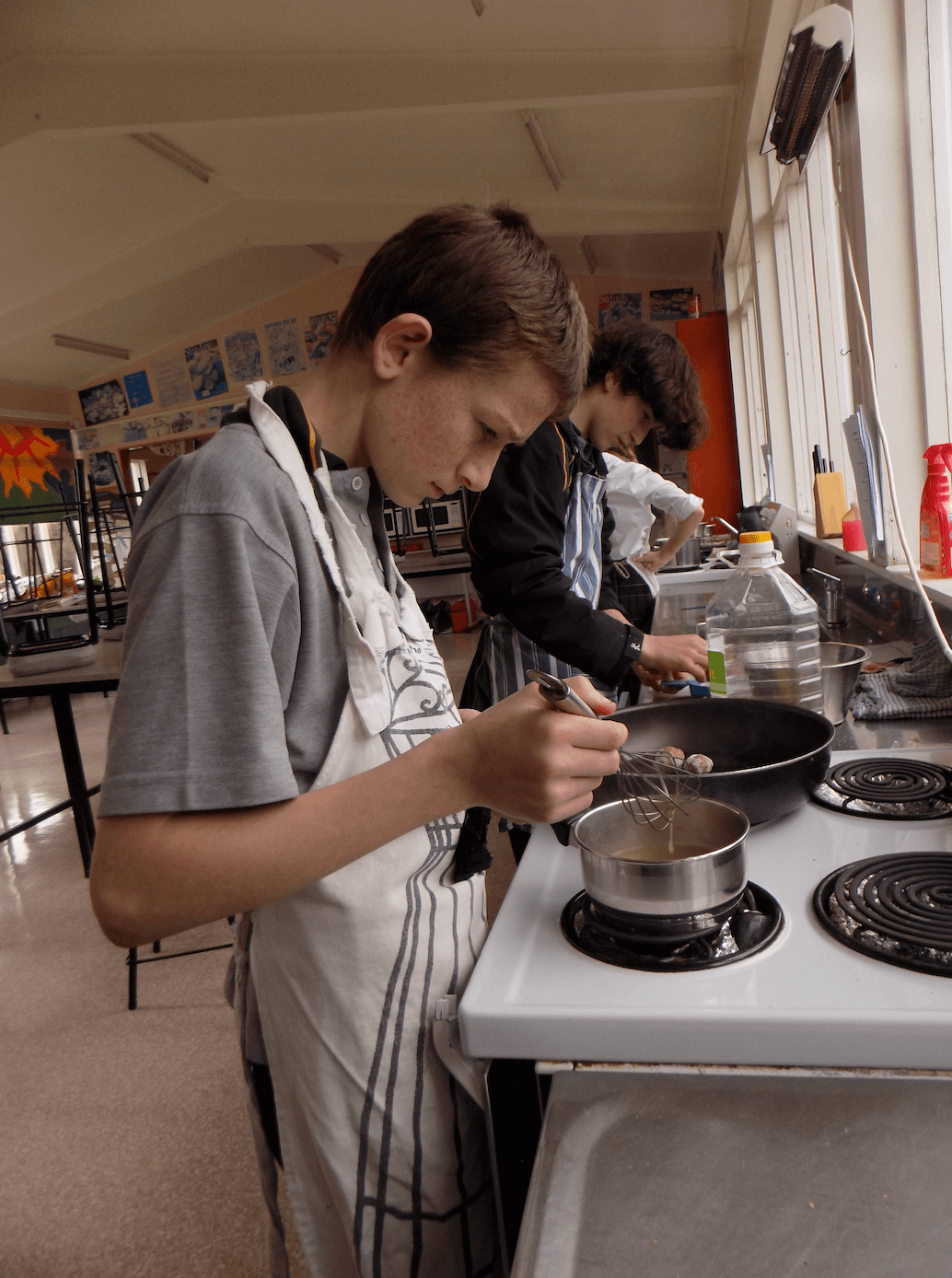 Males cooking in school kitchen